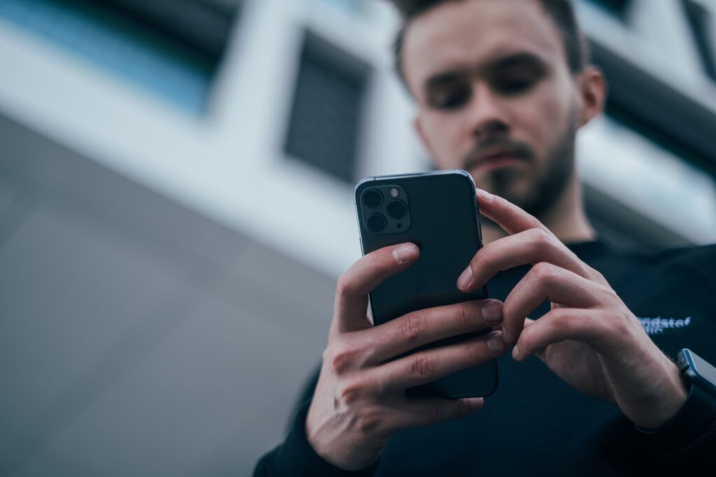 Man checking digital marketing analytics on cell phone