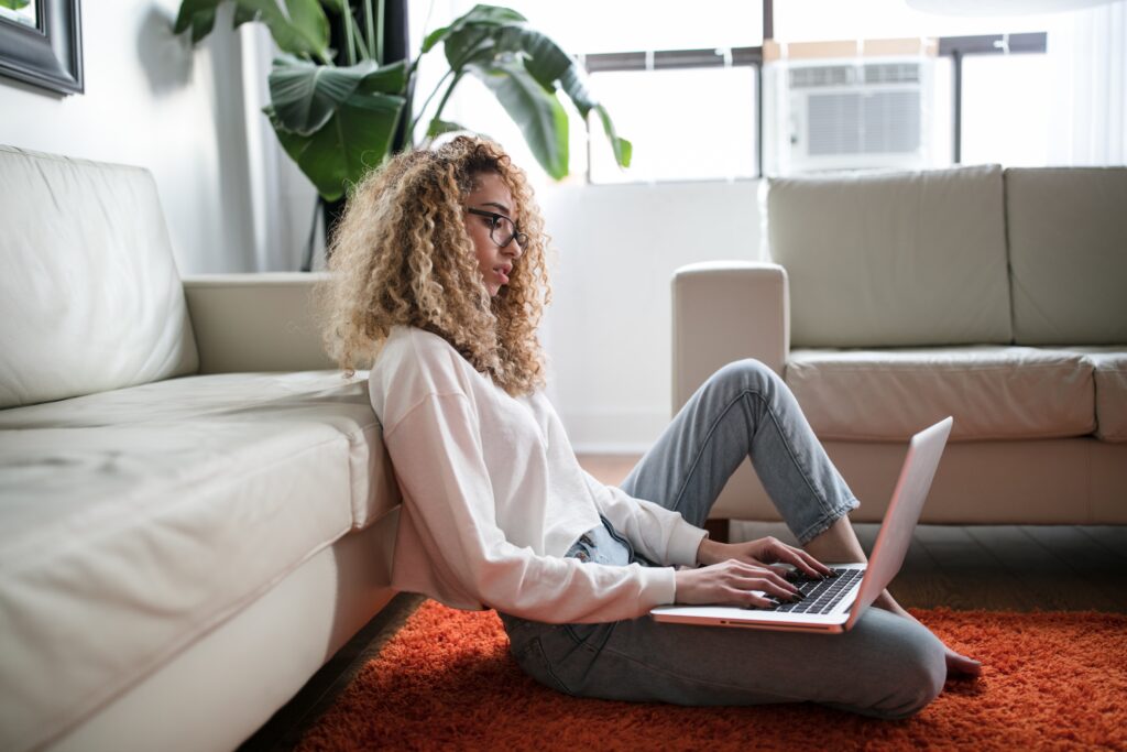 Woman in her living room checking reviews on the computer