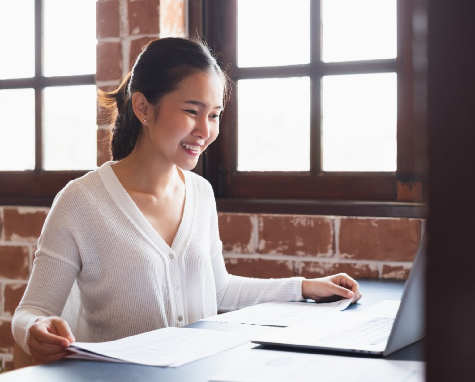 Person looking at laptop and smiling