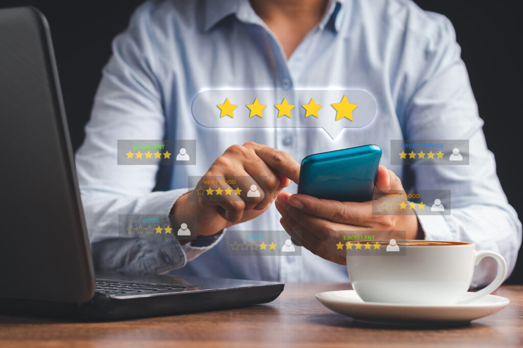 Man using a smartphone give the five-star icon a rating of very