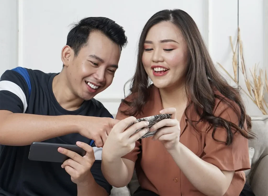 Two customers looking at a smartphone