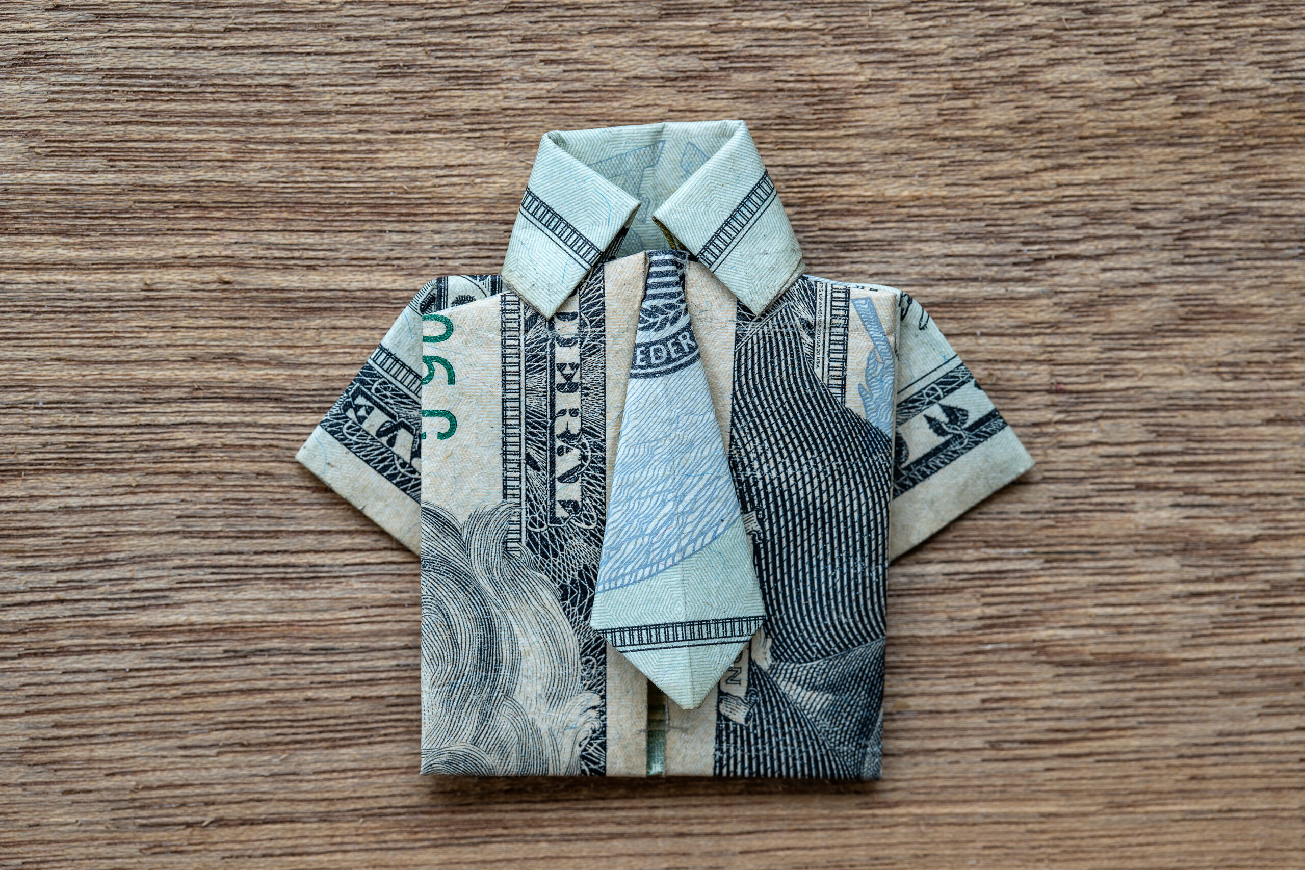 A dollar bill folded to look like a shirt